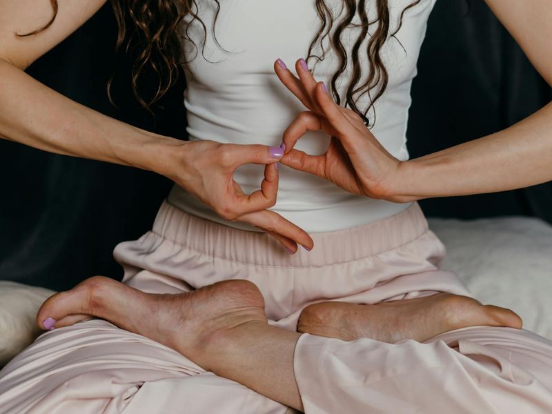 Close-up of a person's hands in a meditative yoga mudra.